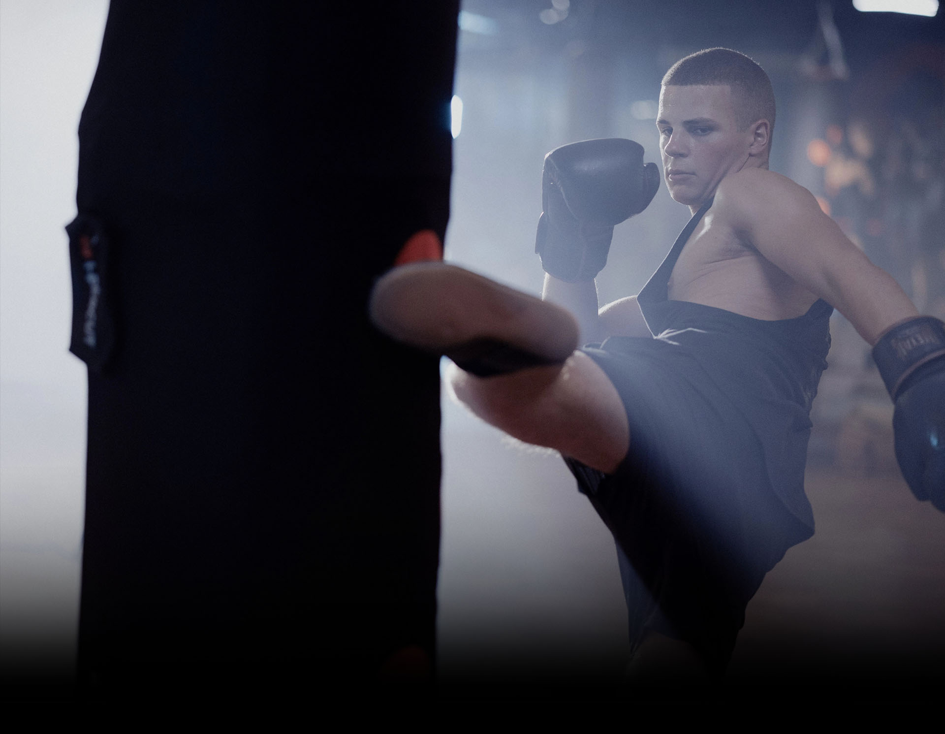 boxing with feet and fists on a punching bag